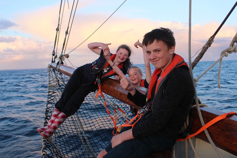 3 kids on bow of yacht