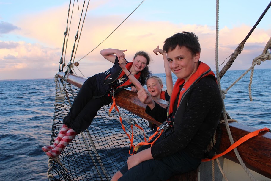 3 kids on bow of yacht