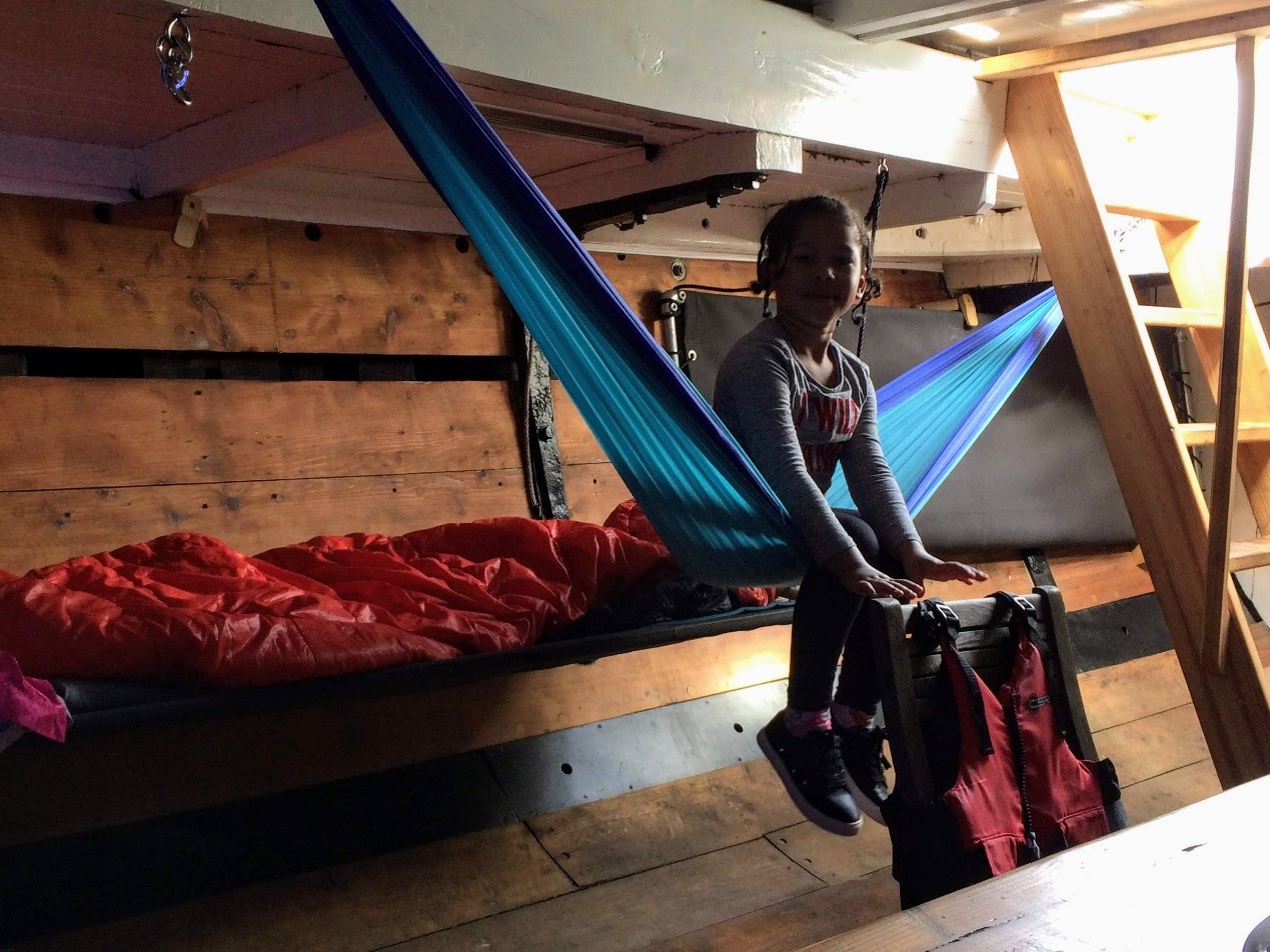 girl sitting on bed inside yacht