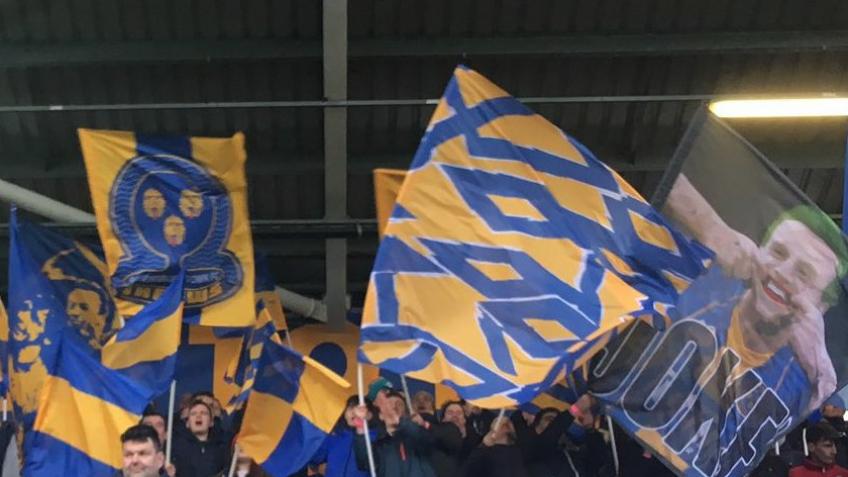 Create a sea of blue and amber in the South Stand